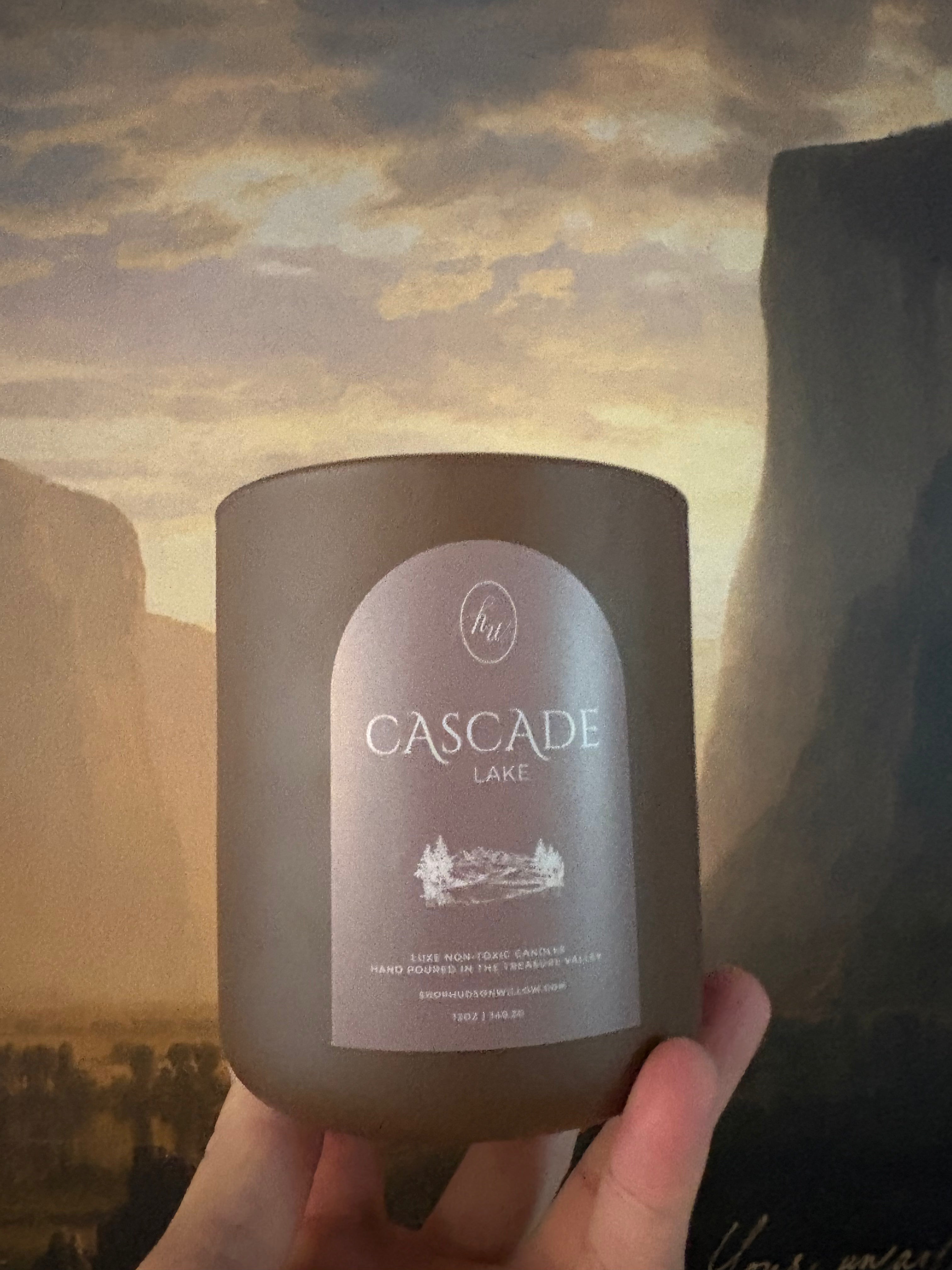 matte chocolate brown candle with the words cascade lake and Hudson + Willow on the label 